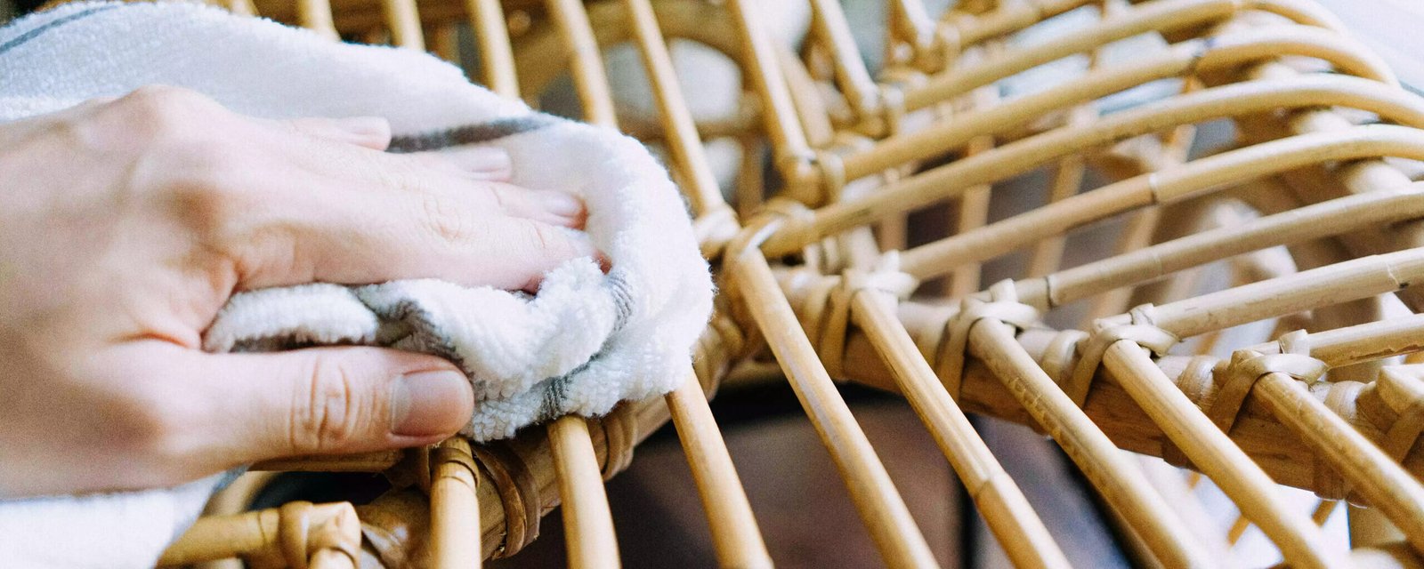Using An Old Cloth To Wipe A Piece Of Rattan Furniture Luminatura